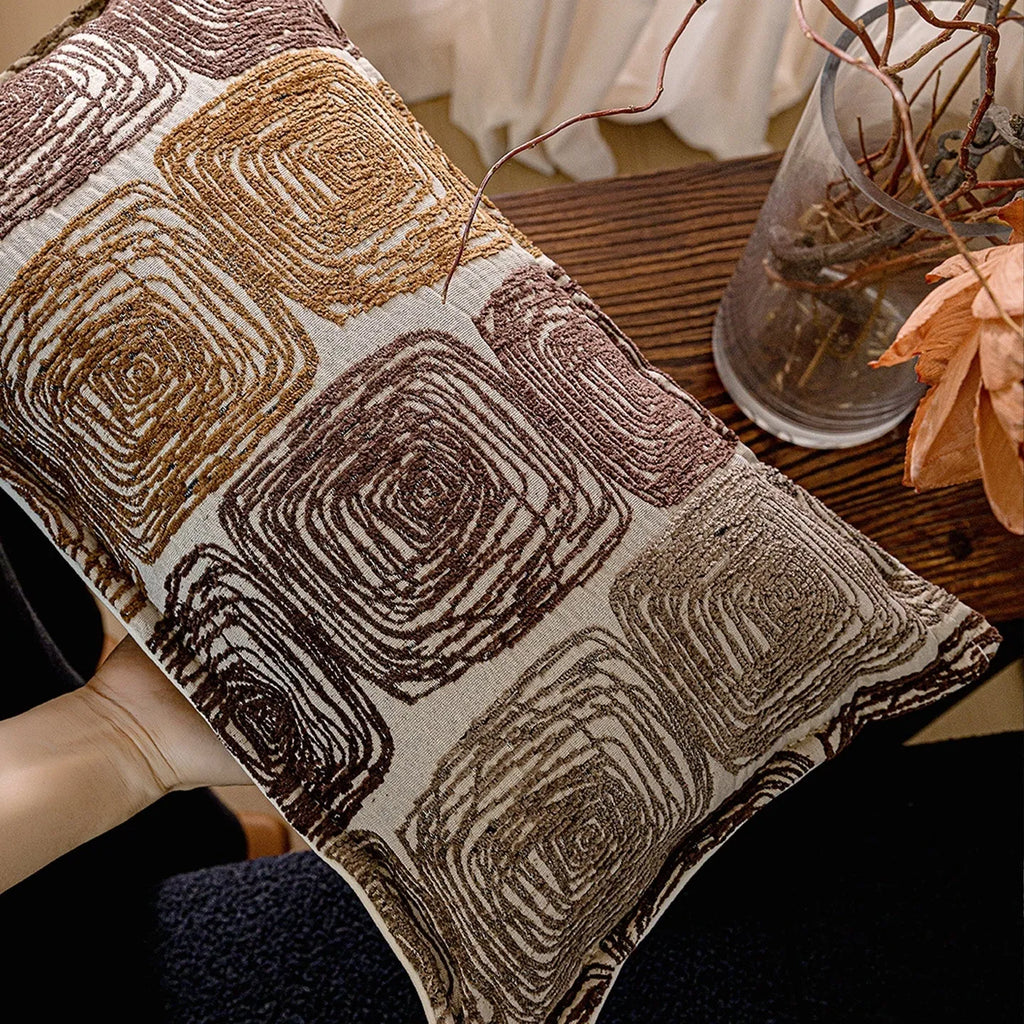 Abstract coil pattern pillow cover in cream and coffee colours with feather velvet texture