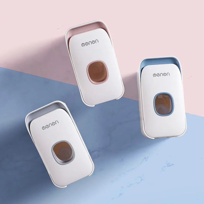 Automatic toothpaste dispenser in blue, grey, and pink colours made from ABS plastic.