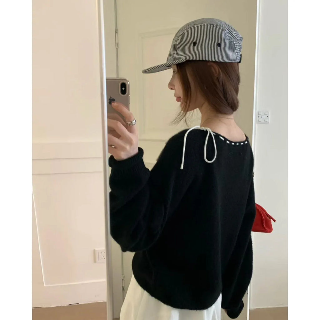 Grey loose-fit women's pullover knitwear on a hanger