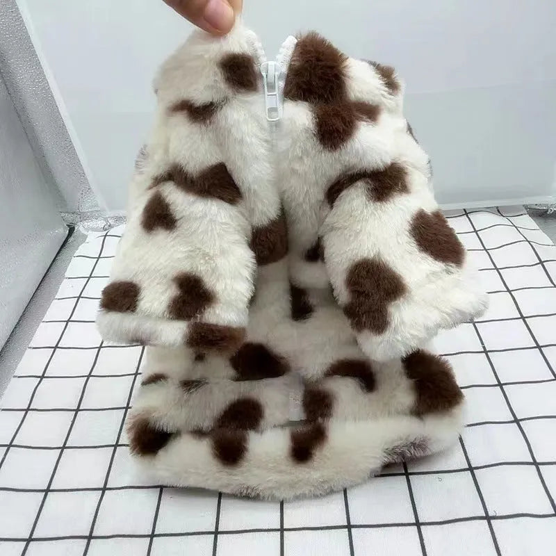Small dog wearing a plush pink warm coat for cold weather protection