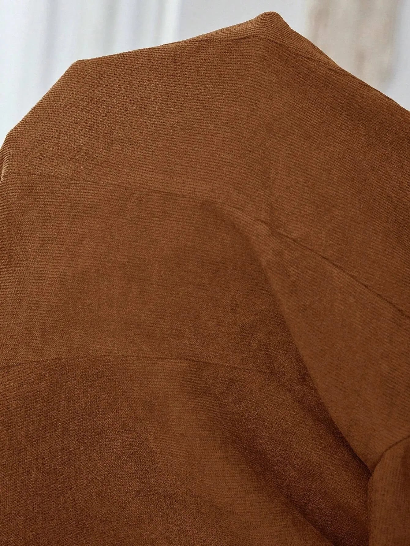 Brown men's single-breasted lapel collar coat with long sleeves on hanger