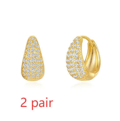 A pair of round, geometric brass earclip earrings with a gold electroplated finish.