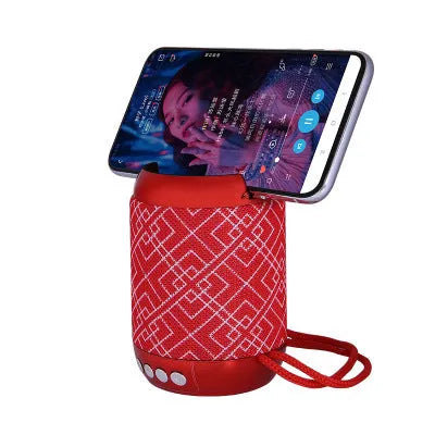 Mini wireless Bluetooth speaker with fabric covering in blue, showing button controls and compact size