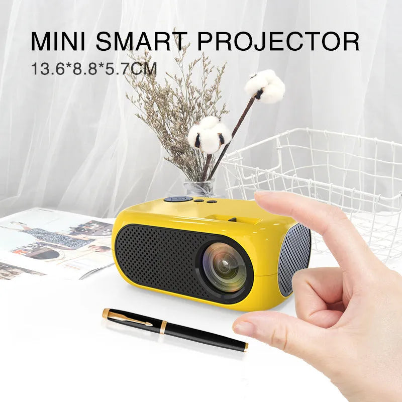M24 micro mini portable LED projector in gold or white colour on a dark surface