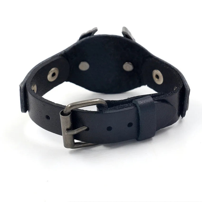Black leather bracelet with geometric eagle watch-button clasp showing tapered 1.7-3.8cm width