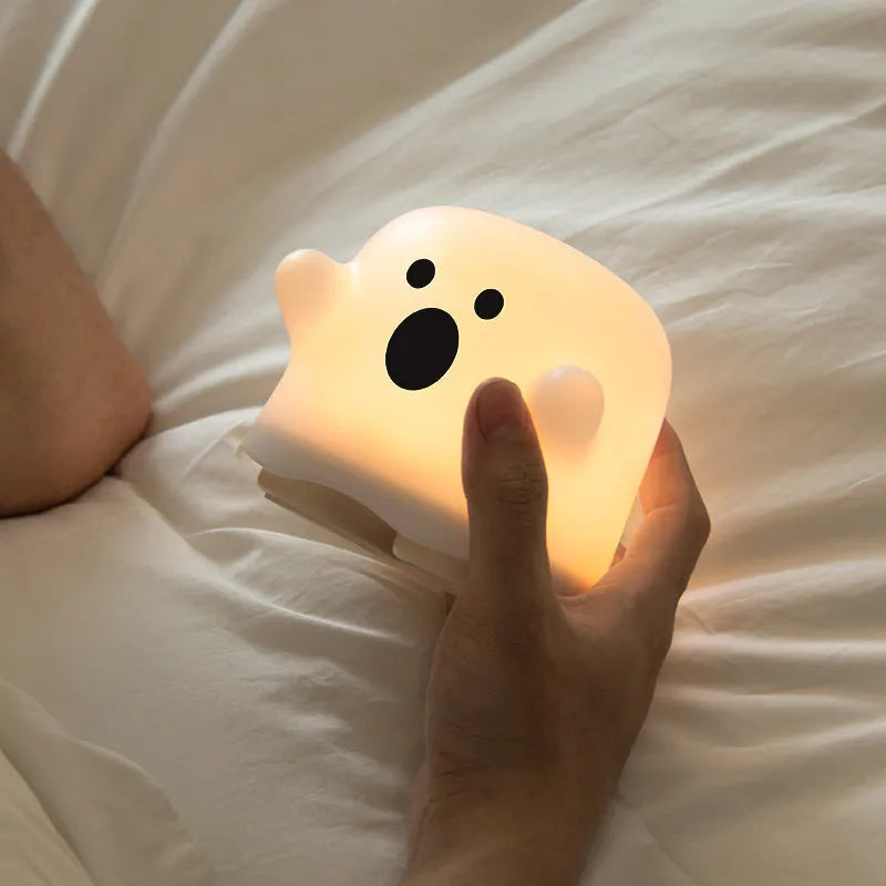 Silicone night light LED touch sensor lamp for kids bedroom in pink, showing soft glow on a bedside table