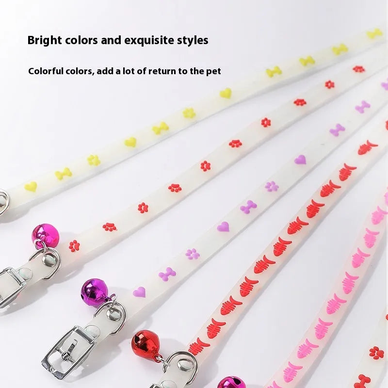 Cat wearing luminous collar with silicone chain and metal bell in paw print style