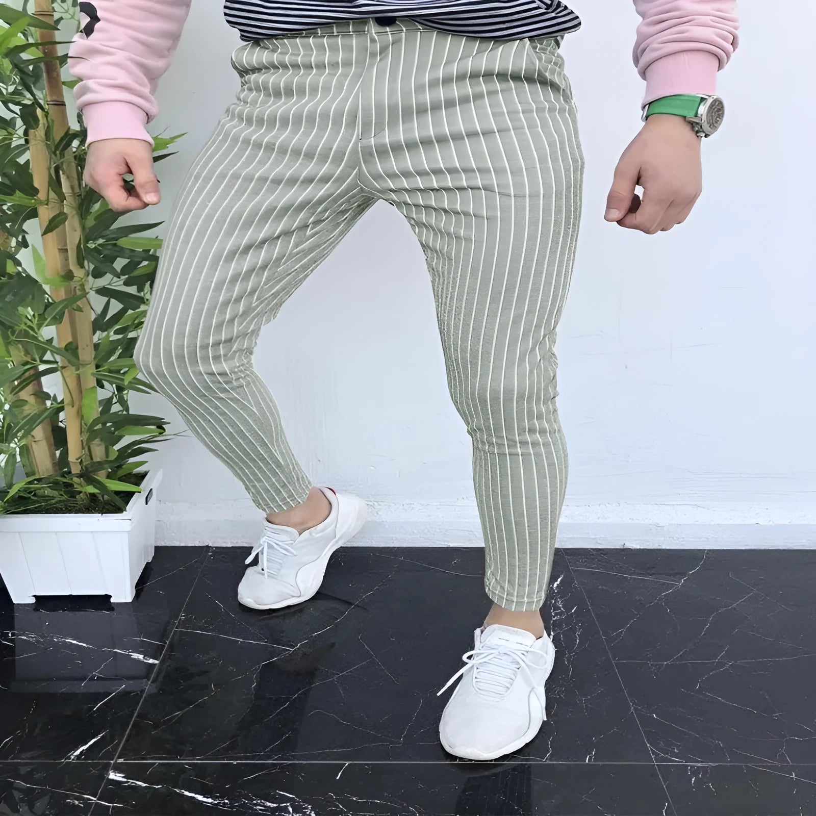 Men's slim-fit plaid casual trousers in a straight-leg style on a neutral background.