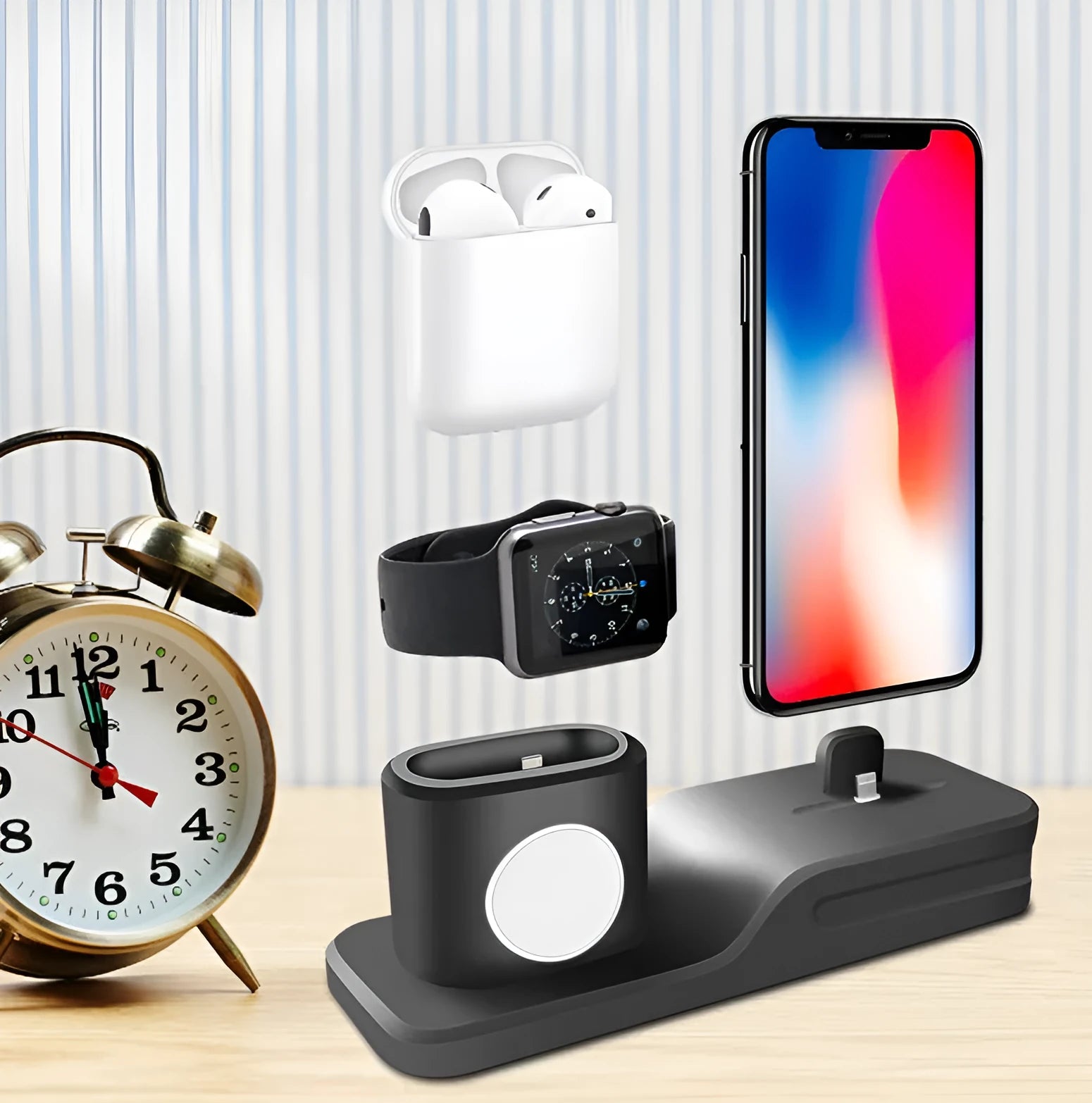 Black 3-in-1 silicone charging base for iPhone, iWatch, and AirPods on a desk