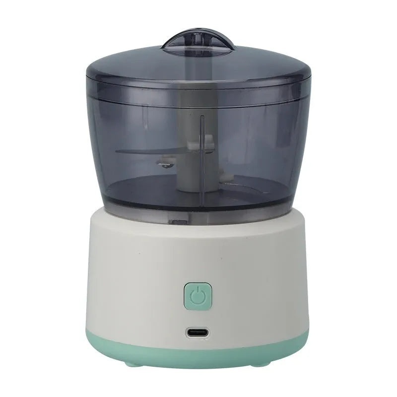 Mini meat grinder with white body, transparent 225ml cup, and anti-slip base on a kitchen countertop