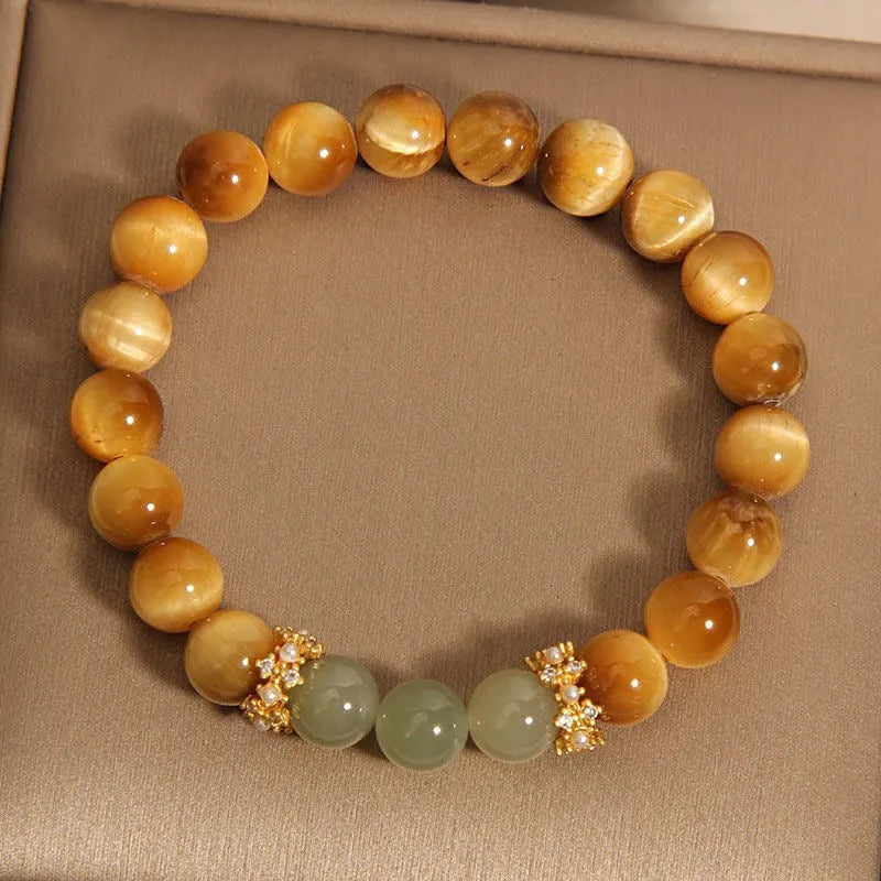 Natural tiger's eye and Hetian jade bracelet with diamond treatment showing golden gourd pattern