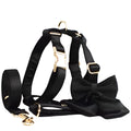 Pet harness set showing cloth collar, leash, decorative bow, and matching vest in four available sizes