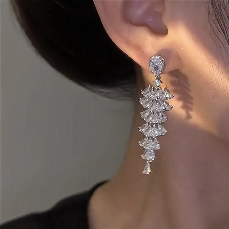 Pair of silver-coloured Christmas tree drop earrings with pagoda shape on stud fastenings.