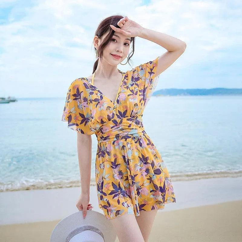 Women's yellow floral one-piece swimsuit made from polyester with full coverage design