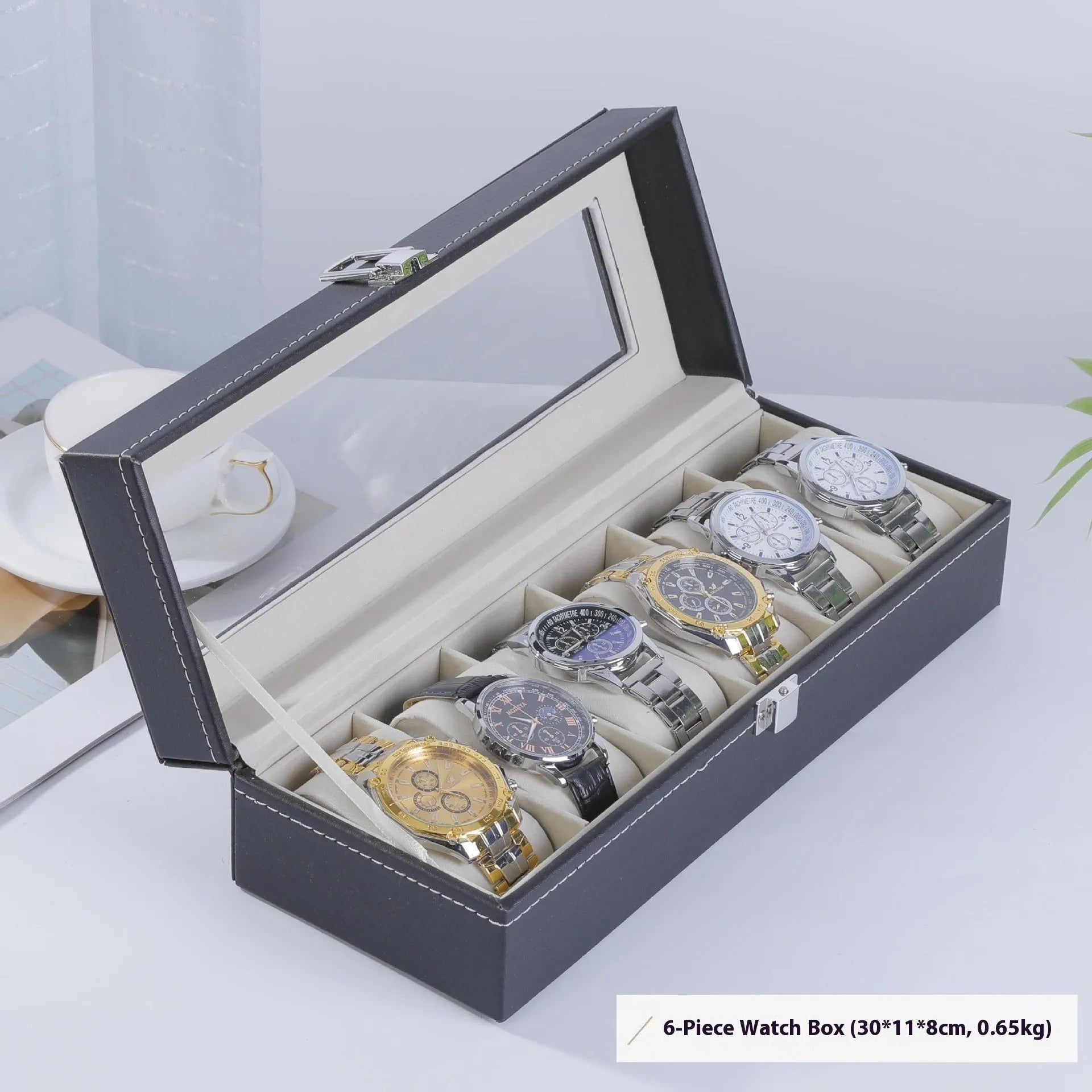 Grey leather watch storage box with clear dustproof lid showing interior watch compartments