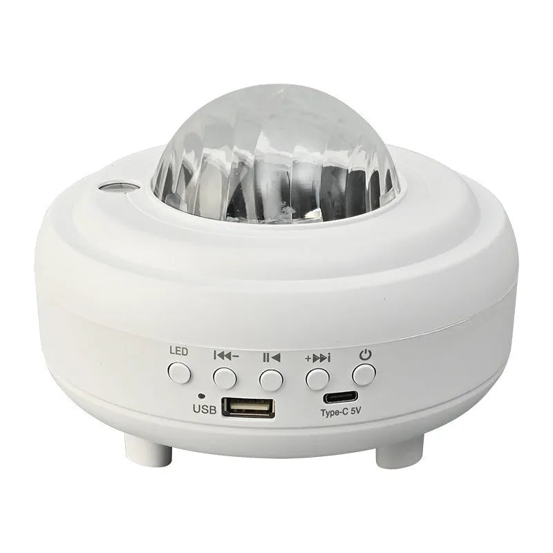 Galaxy star projector night light with 7 light effects and Bluetooth speaker in white rechargeable finish on a bedside table