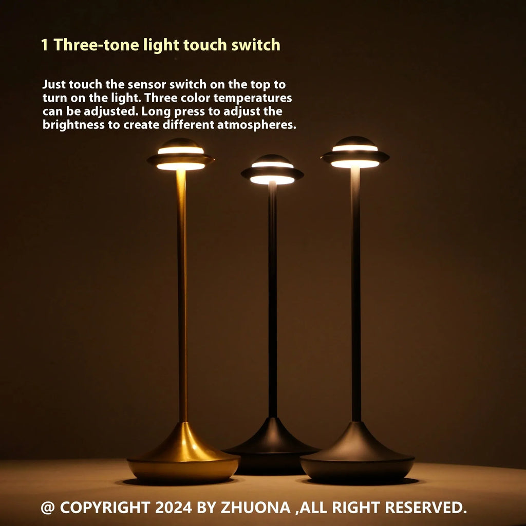 Modern UFO-shaped metal desk lamp with touch-sensitive base in black, gold, or grey finish.
