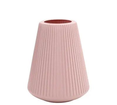 Colourful melamine plastic decorative flower vase on a desktop, 16cm wide by 20cm tall.