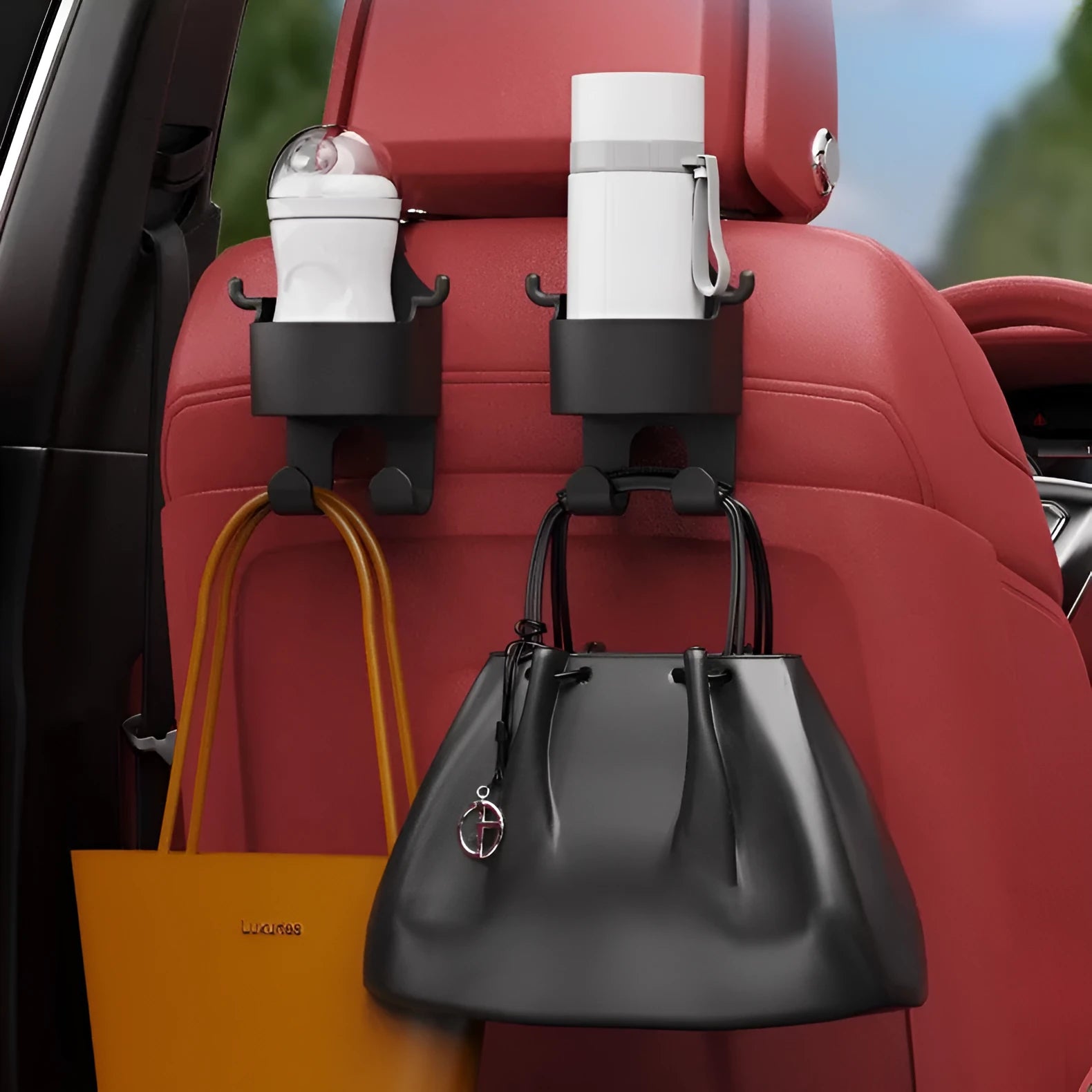 Black plastic car seat back hook organiser with cup holder mounted on vehicle headrest