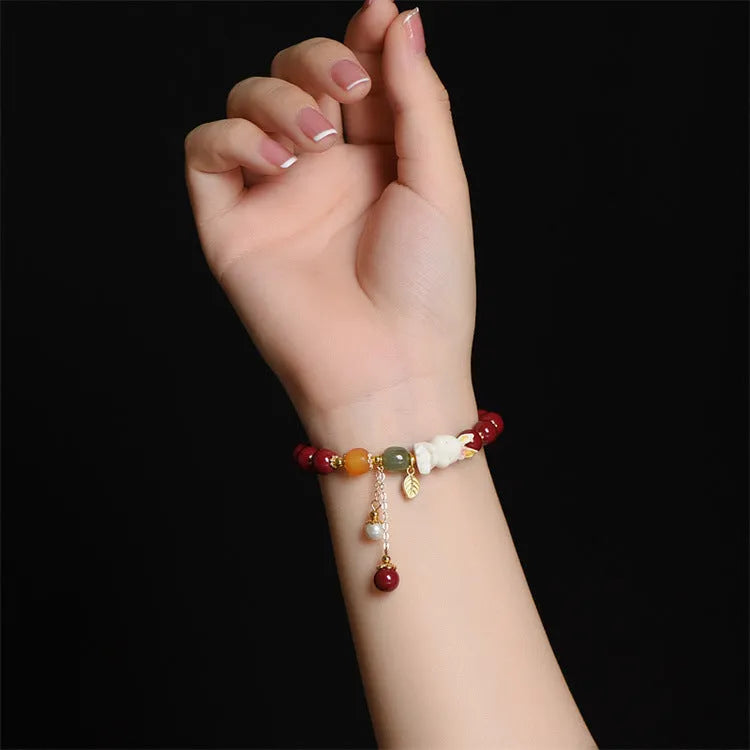 Natural cinnabar rabbit charm bracelet in Chinese national style, available in 8mm or 10mm diameters