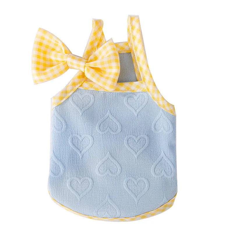 Small dog wearing heart texture vest with bow suspenders in blue colour