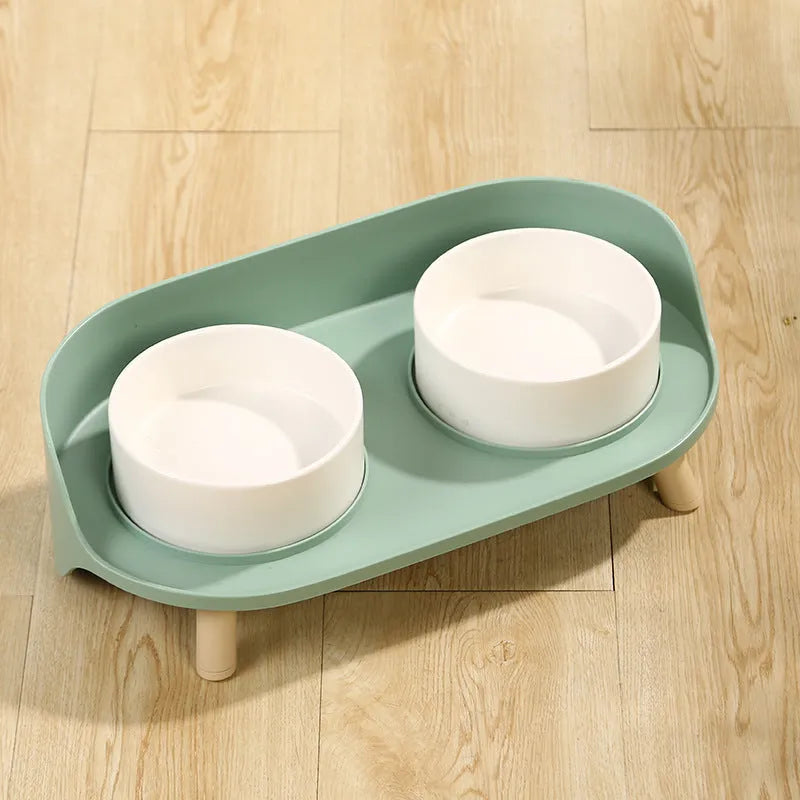 Tilted double bowl pet feeder in green with separate compartments for food and water