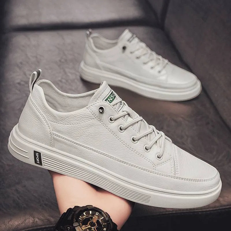 White casual men's shoes with round toe and flat low-heel design on neutral background