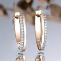 Women's V-shaped geometric copper ear clips in champagne gold with white diamond accents