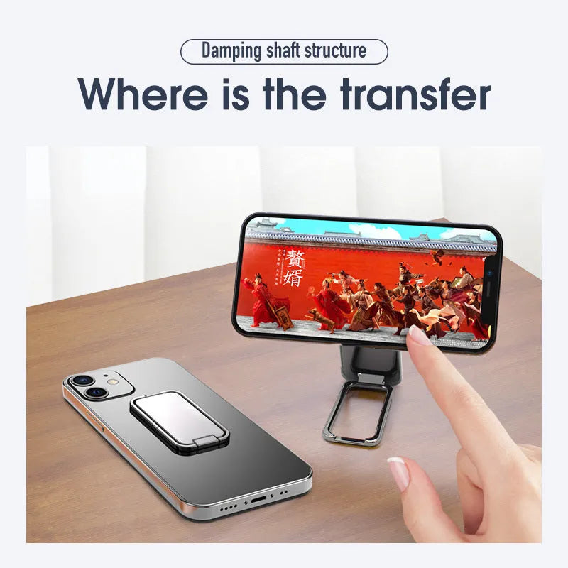 Foldable zinc alloy phone holder ring buckle in silver on a desk propping an iPhone at an angle.