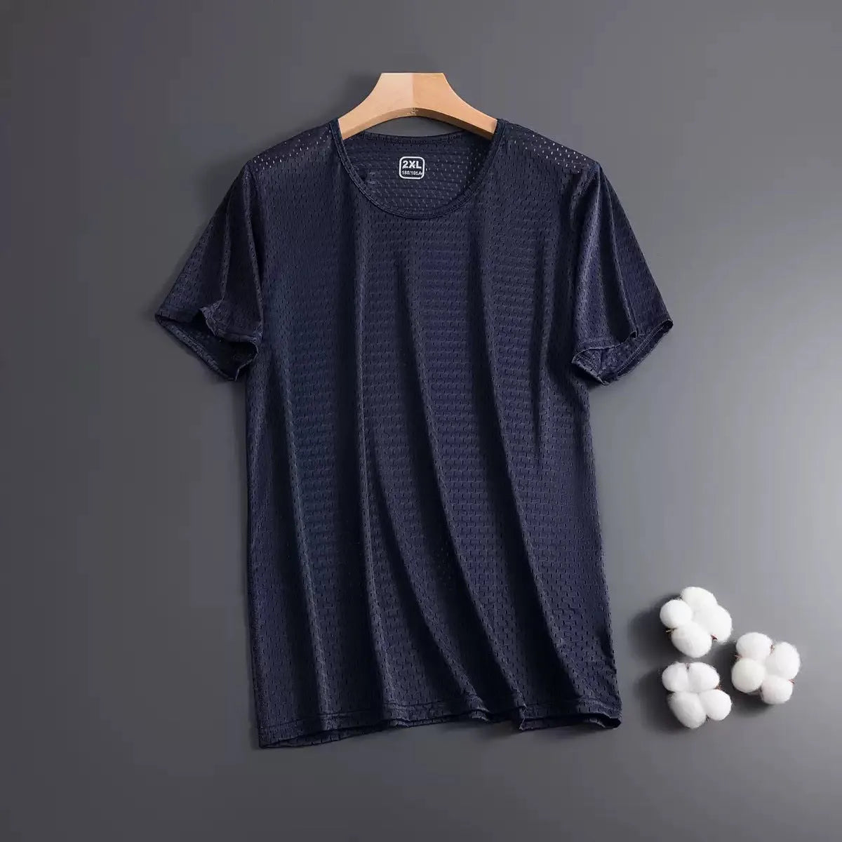 Man wearing a loose-fit black Ice Silk short sleeve t-shirt with crew neck for summer.