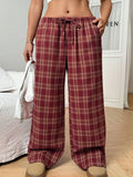 Women's red casual loose trousers with drawstring waist and plaid patch pockets laid flat.