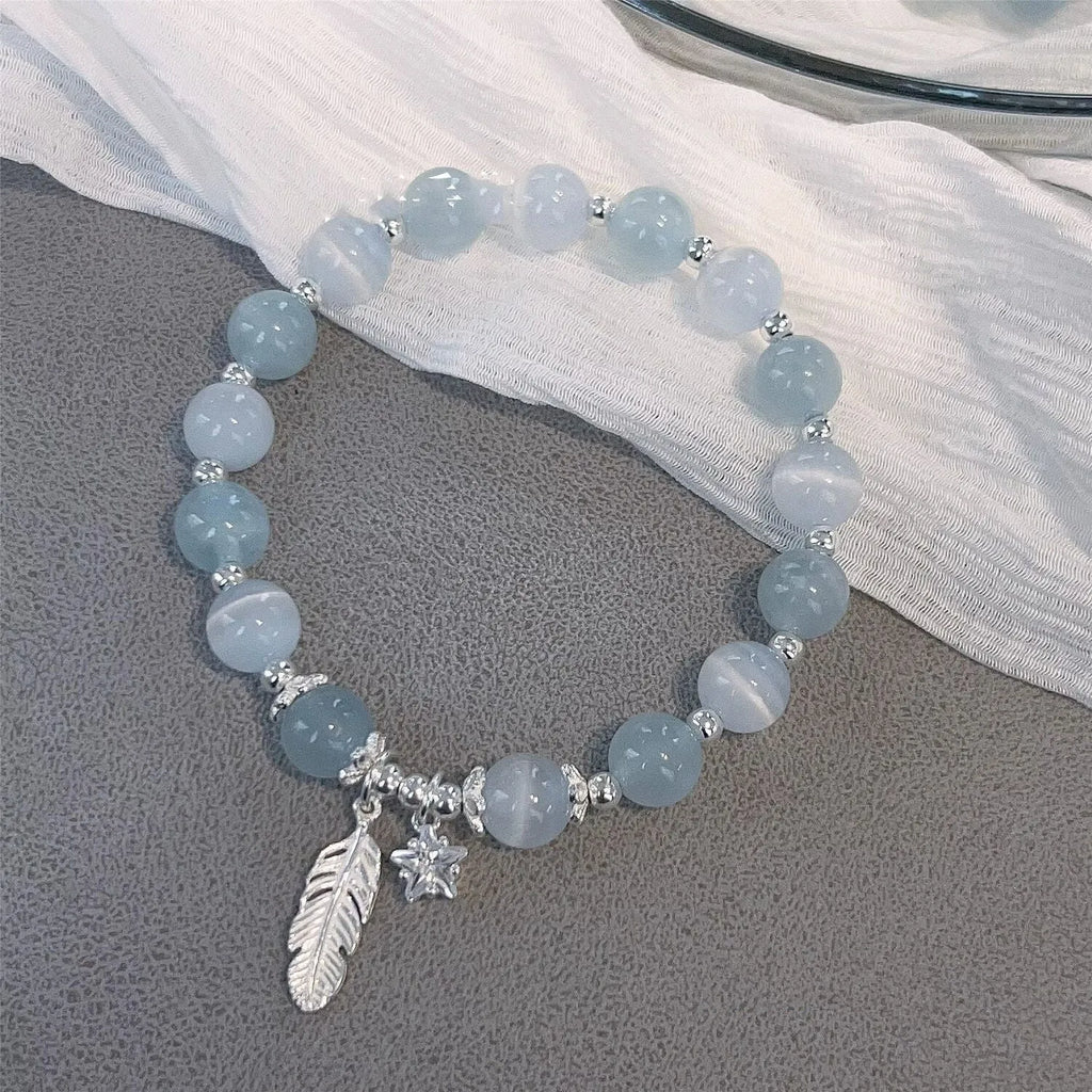 Small white girl crystal bracelet in feather XINGX blue moonlight with eight Awn star motif on wrist
