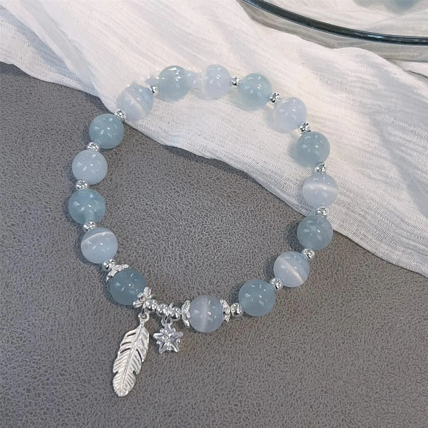 Small white girl crystal bracelet in feather XINGX blue moonlight with eight Awn star motif on wrist