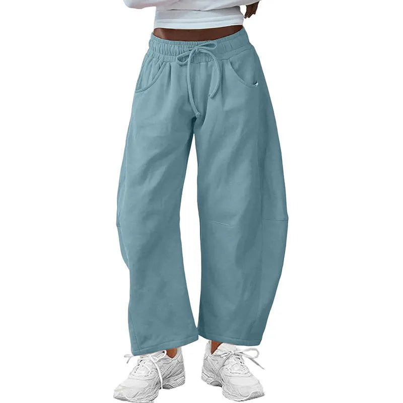 Loose cropped sweatpants with elastic drawstring waist and pockets in street fashion styling