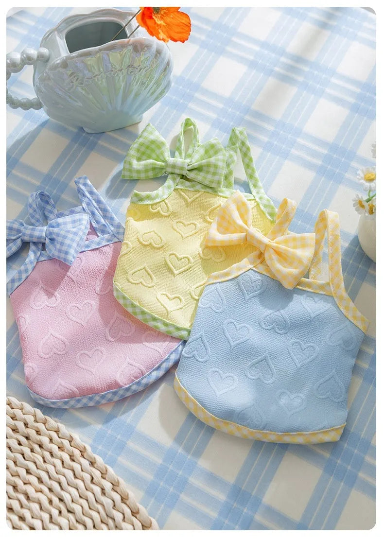 Small dog wearing heart texture vest with bow suspenders in blue colour