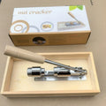 Mechanical walnut cracker with wood body and aluminium mechanism on a table