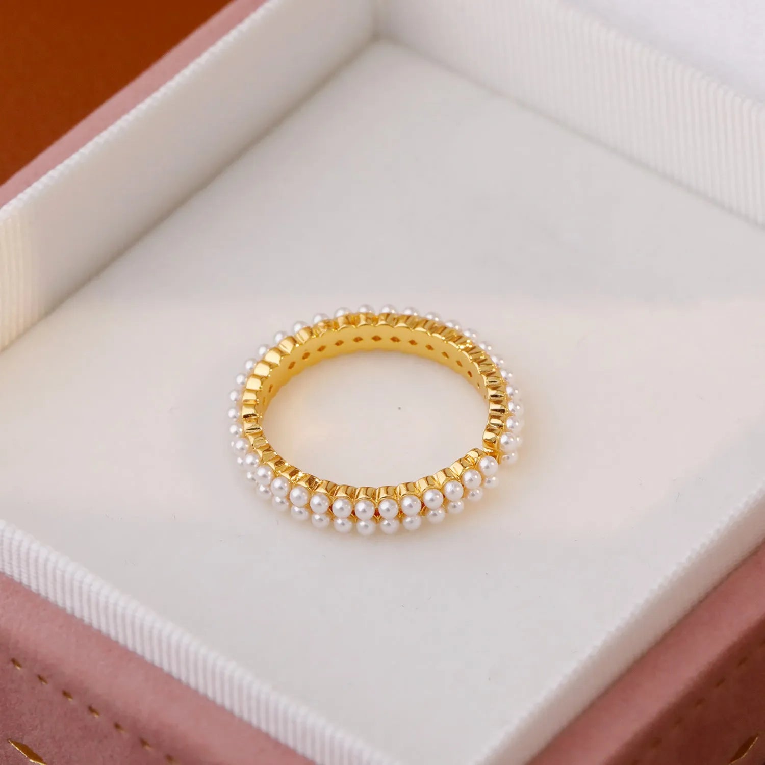 Gold geometric open mouth ring with pearl detail on female hand