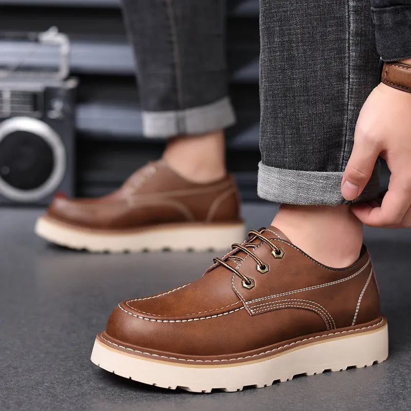 Men's black low top British retro worker boots with round toe and rubber sole.