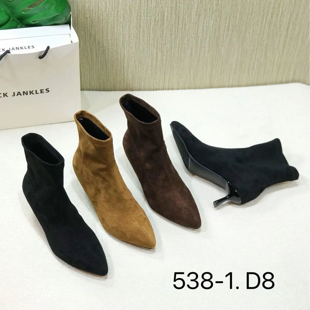 Women's black pointed toe ankle boots with a stiletto heel on a plain background