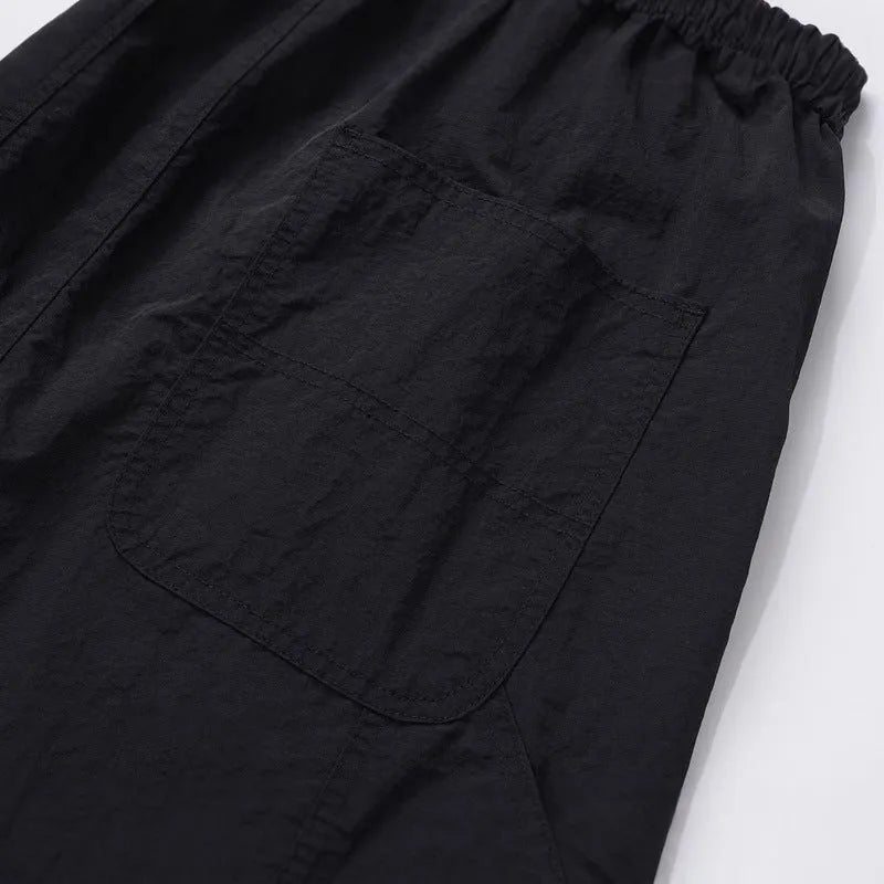 Men's black baggy paratrooper pants with elastic drawstring waist, three-dimensional cutting, acetate fibre blend