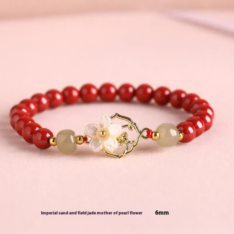 Natural Hetian jade white butterfly Bells of Ireland sinology bracelet with cinnabar beads and lotus motif on women's wrist