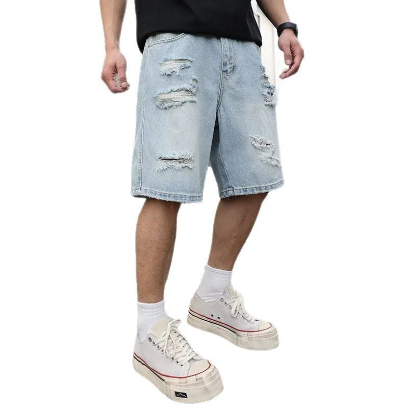 Men's light blue ripped denim shorts with distressed detailing and straight leg cut