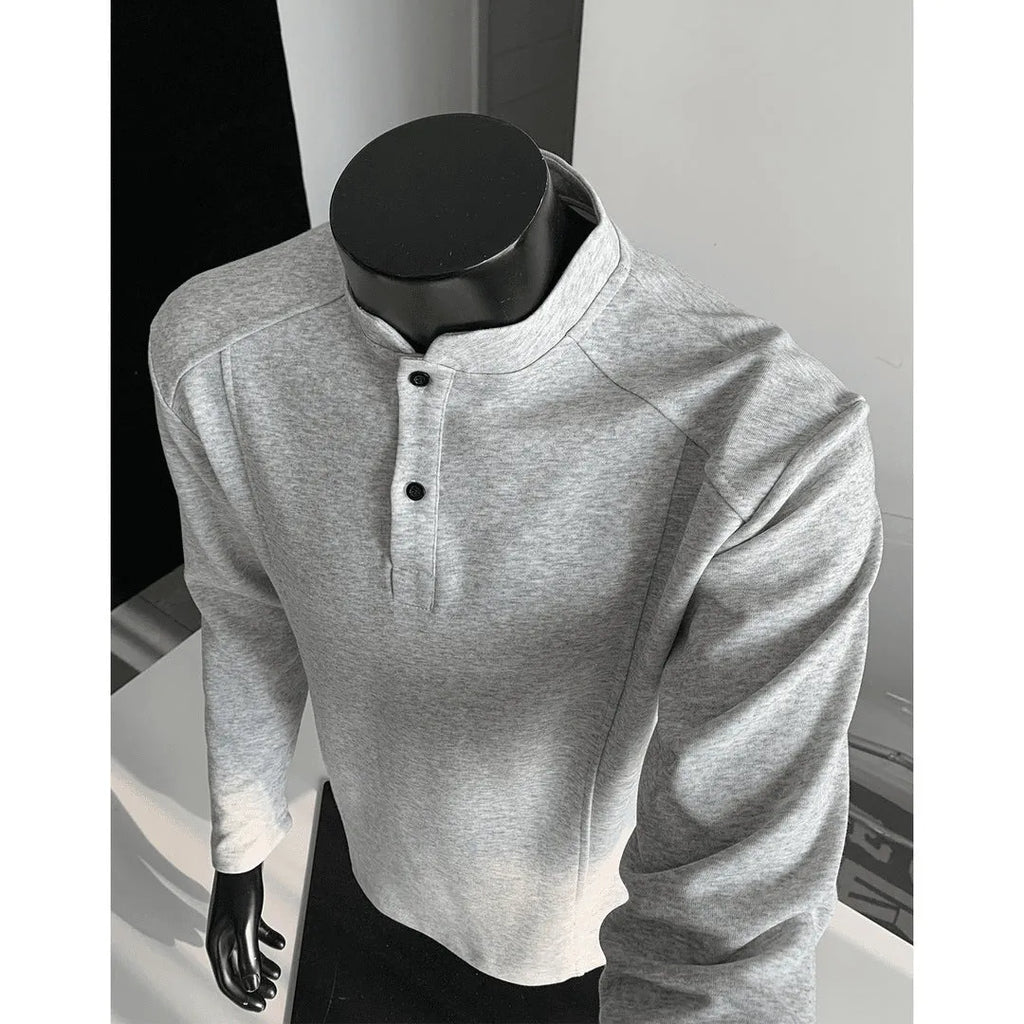 Man wearing a grey patchwork stand-up collar polo shirt with asymmetric shoulder detail