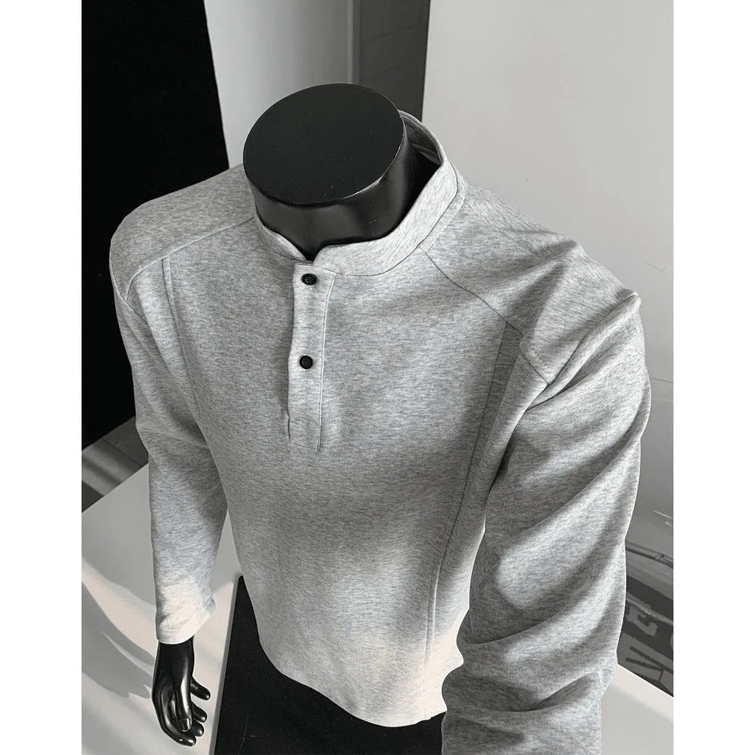 Man wearing a grey patchwork stand-up collar polo shirt with asymmetric shoulder detail