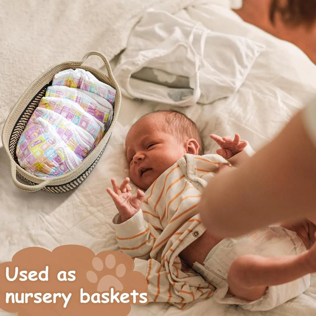 Small light beige woven cotton rope storage basket with handles on a wooden surface.