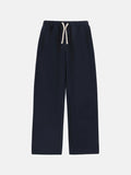Man wearing thick black fleece-lined sweatpants with an elastic drawstring waist.