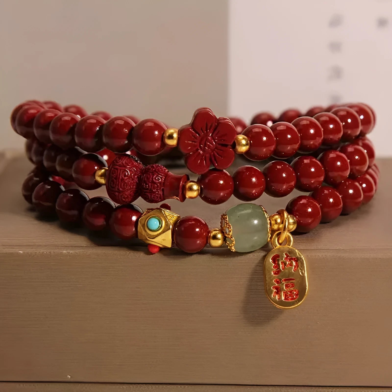 Polished cinnabar gourd five petal flower bracelet 6mm multi-circle on display