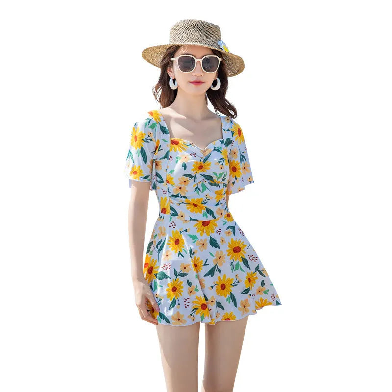 Women's one-piece slimming dress-style swimsuit with blue floral printed pattern on polyester fibre fabric