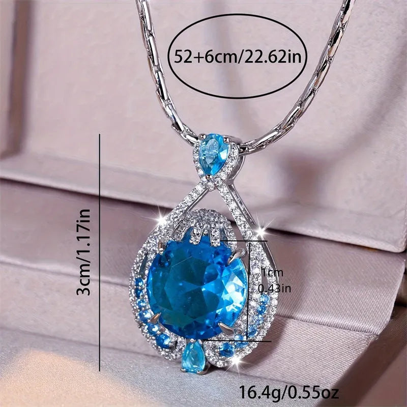 Close-up of a women's geometric necklace with a blue crystal pendant on a water wave chain.