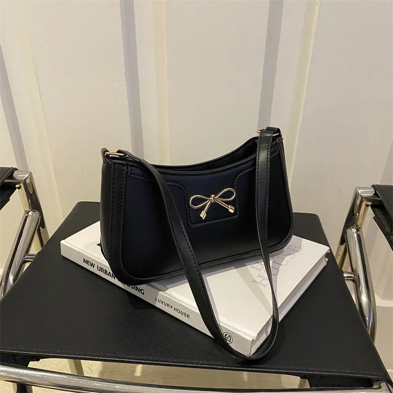 Portable PU shoulder bag in western baguette style with bow detail, 24x14x5 cm, available in multiple colours